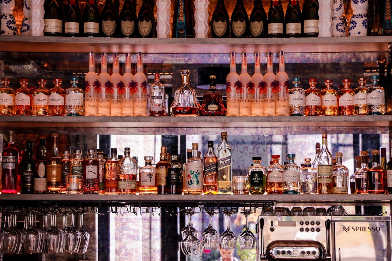 creative-02 A well-stocked bar display featuring various bottles of liquor and glassware, perfect for nightlife scenes.