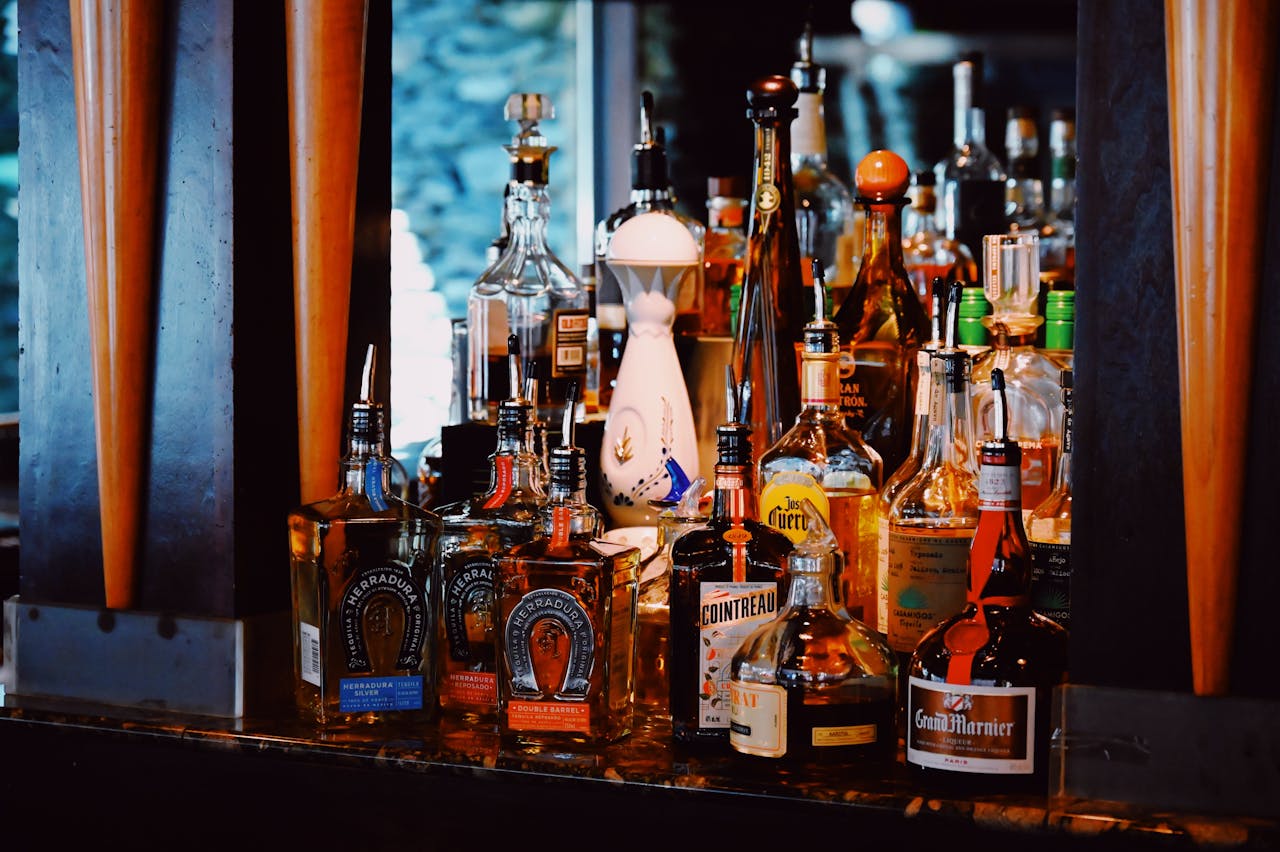 mobile-01 An inviting bar scene showcasing a vibrant assortment of liquor bottles.