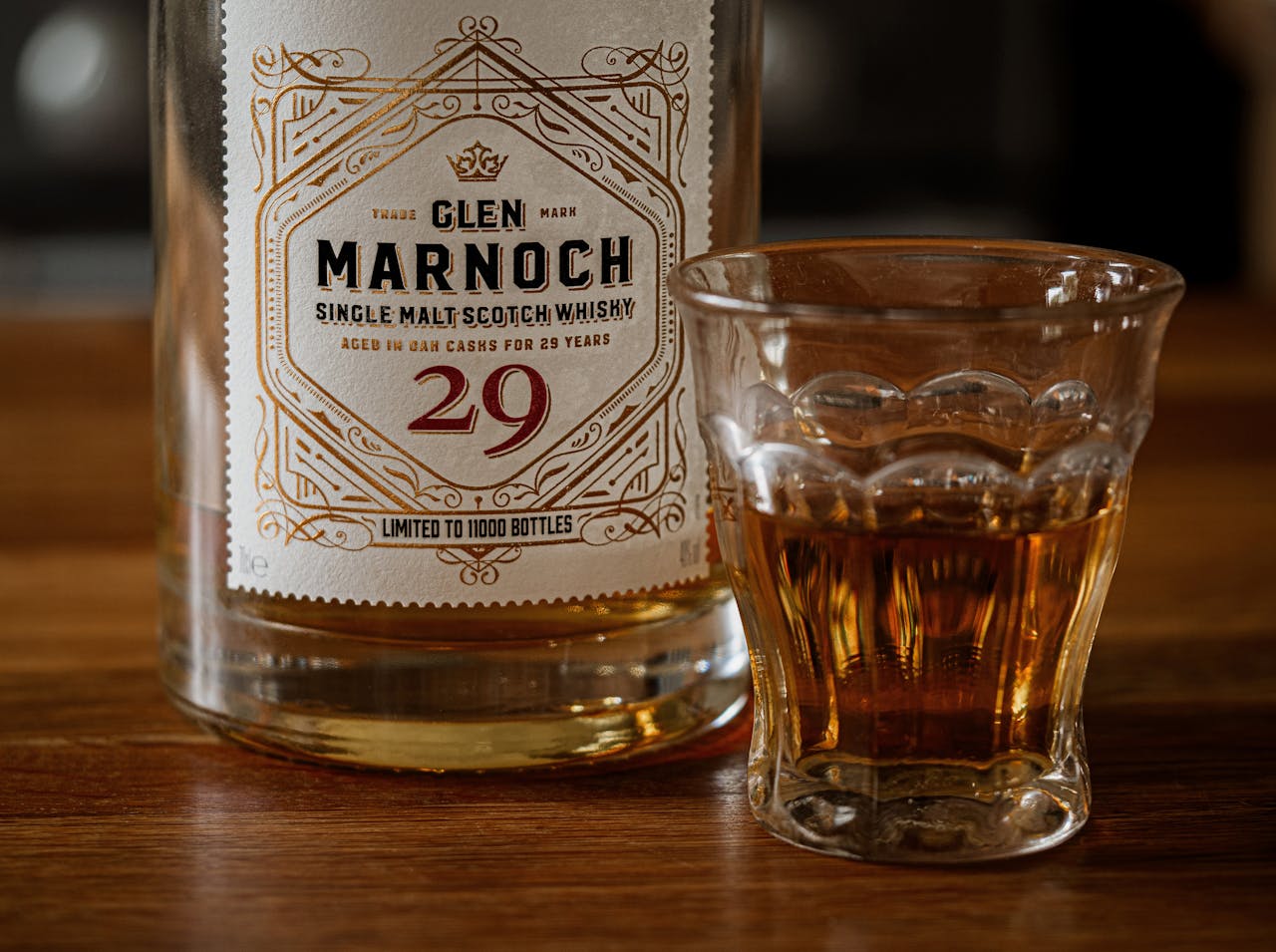 Close-up of Glen Marnoch whisky, aged in oak casks, with a whisky glass.